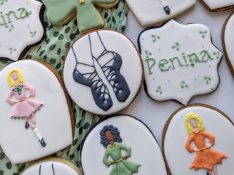 Cookies with Irish step dance theme with dancers, shoes, shamrocks in various colors