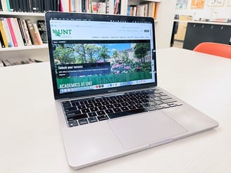 Image of a laptop opened to a University of North Texas web page.