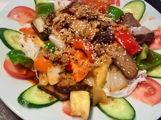 a plate of food with vegetables and tempeh