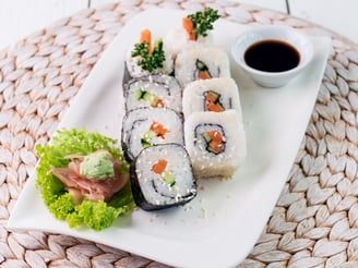 a plate with veggie sushi and sauce