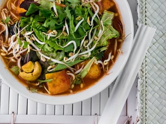 a bowl of soup with vegetables and noodles