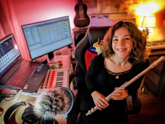 a woman in a recording studio with a microphone and a microphone