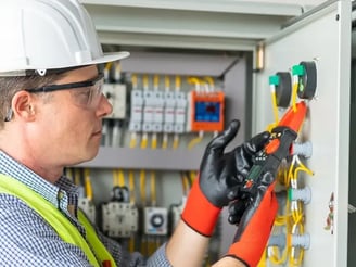 a man in a hard hat and safety glasses