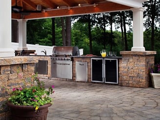 Outdoor kitchen and fireplace combo in Palo Alto with natural stone finish