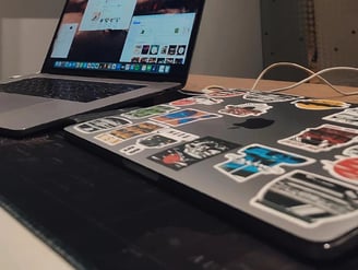 a laptop computer sitting on a table with a laptop and a monitor