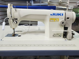 a sewing machine with a blue and white background