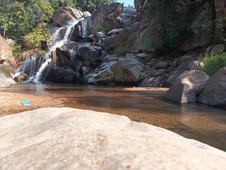 a small waterfall in a stream in a rocky river