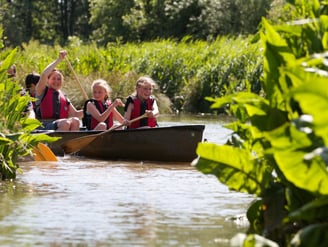 a group of people in a canoe on a river