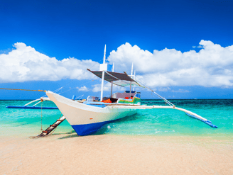A cozy small boat on a very beautiful island with white sand and crystal clear blue sea in Boracay 