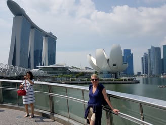 Lady poses in front of the Marina Bay Sands Hotel and the ArtScience Museum