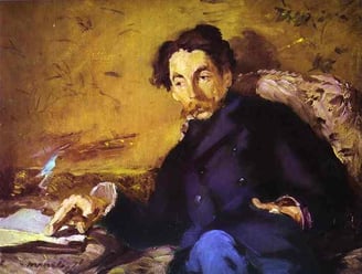 a man in a blue suit sitting in a chair