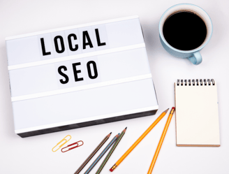Local SEO concept with sign, coffee, notebook, and pencils, Boost small business online visibility