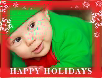 a baby wearing a green elf hat and a green elf hat
