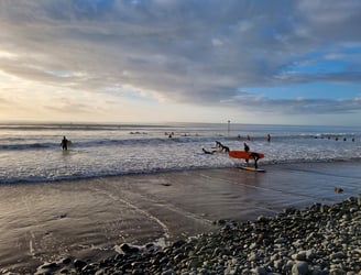 A busy surf lesson at Ynyslas in late evening autumn sunshine