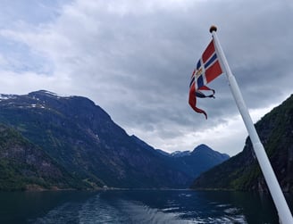 Flag and mast with river and mountain view in Norway