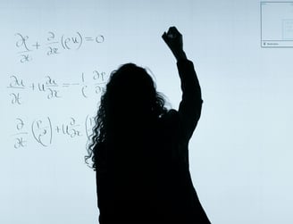 a person standing in front of a white board with a white board