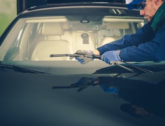 a man in a blue jacket is holding a wrenet