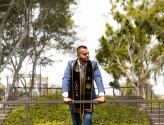 Jose Roldan in a graduation gown and caprisp at CSULB