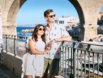 Relaxed couple portrait at Vallon des Auffes with fishing boats and iconic bridge
