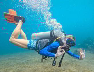 Female Scuba Diver in the water signaling ok, feeling safe