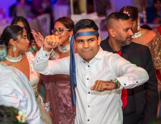 man aan het dansen met een stropdas om het hoofd