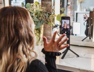 a woman taking a selfie with her phone