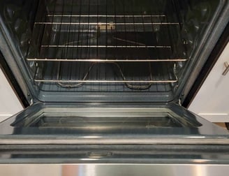 Immaculately cleaned oven interior showing polished racks and a grease-free surface.