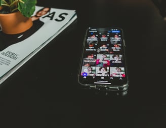 A phone displaying Instagram reels and social media clips for podcasts.