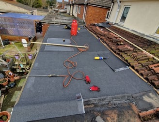 Felted roof being repaired