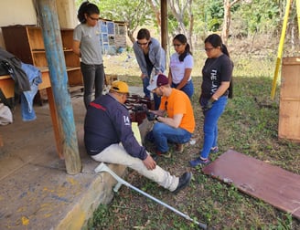 C.J. is teaching a group of students about safely measuring battery voltage. 