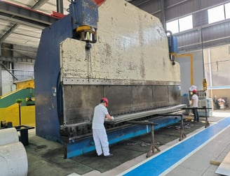 PMI Piping workers are bending alloy plate by bend machine