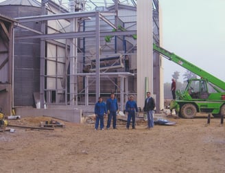 a group of people standing around a construction site