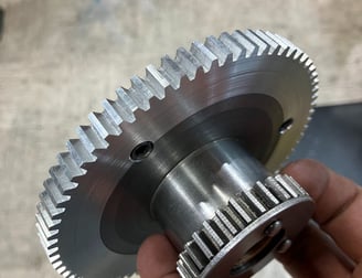 hand holding a machined gear