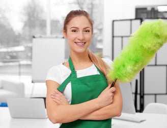 a woman in green aprons holding a green duster