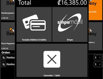 a man in a blue shirt is sitting at a desk with a laptop and a