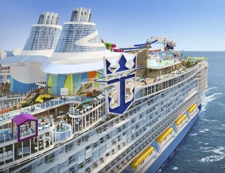 a cruise ship with a large cruise ship in the background