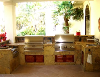 out side kitchen with 2 grills and sink by river oks builders 