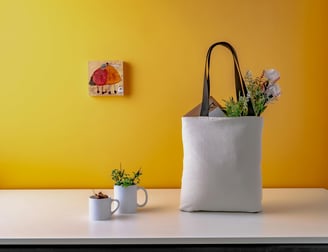 flowers in a tote bag and custom mugs