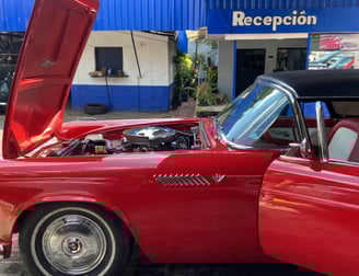 a red car with a red car hood up