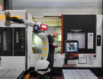 a man in a black suit and a robot