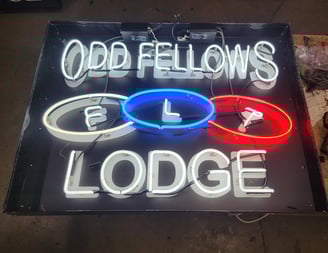 a neon sign that says ODD FELLOWS LODGE