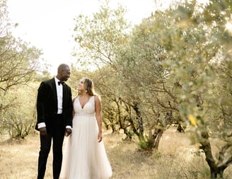 Provence elopement couple in olive grove sharing a romantic gaze, captured by fine art photographer