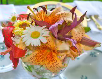 a vase with flowers on a table as wedding decoration