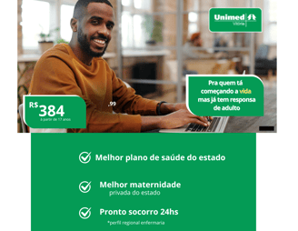a man sitting at a laptop computer with a green screen
