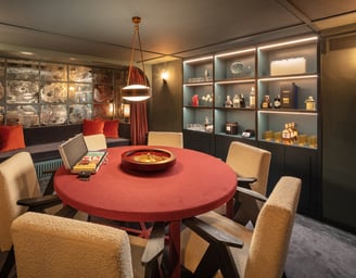 Cigar and poker room at Villa La Gratitud, with roulette table, whiskey bar, and lounge seating.