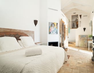 Charming rustic bedroom with art pieces at Finca Santa Katerina