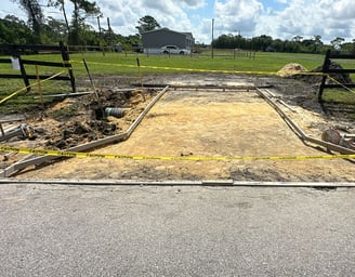 Full concrete driveway installation in Kissimmee, FL with compacted gravel base, rebar reinforcement