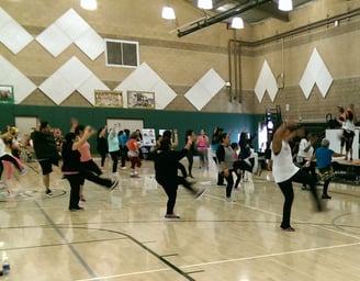 Enhancing Forward Action image of a group of people doing zumba.