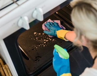 Lady cleaning oven