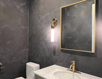 Moody black limewash bathroom with a textured matte finish, creating a sophisticated and modern spa-